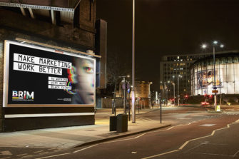 Photo of an empty road at night outside the London IMAX. A billboard under a lit bridge shows the BRiM campaign creative with the headline “Make marketing work better by working with more Black talent”
